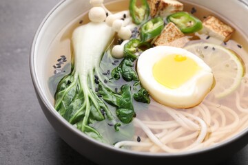 Bowl of vegetarian ramen on grey table, closeup