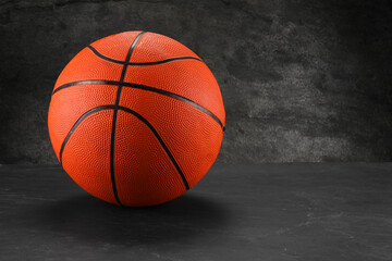 Fototapeta premium Basketball ball on dark gray background, space for text
