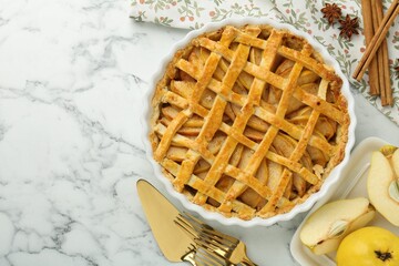 Tasty homemade quince pie served on white marble table, flat lay. Space for text