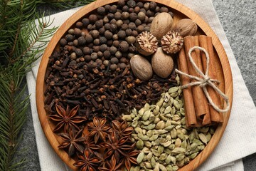 Different spices, nuts and fir branches on table, flat lay