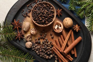 Different spices and fir branches on table, flat lay