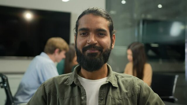 Business portrait Arabian Indian ethnic business man muslim male worker office manager professional businessman CEO employer leader looking at camera sit at table of blurred background team colleagues