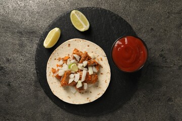 Delicious taco with vegetables, meat and ketchup on grey textured table, top view