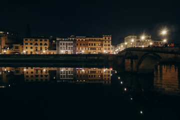 Fototapeta na wymiar Embankment of Arno River at night, in Florence, Italy