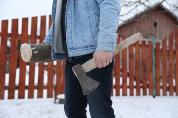 Man with axe and wood outdoors on winter day, closeup