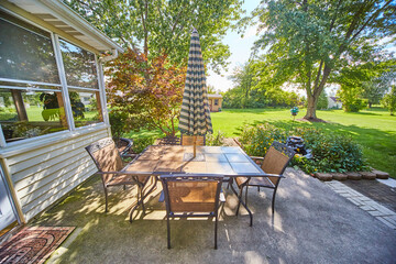 Suburban Backyard Oasis with Patio Dining Set and Garden Decor