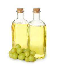 Vegetable fats. Bottles of cooking oils and fresh grapes isolated on white