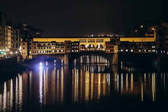 The Ponte Vecchio at night, a medieval stone closed-spandrel segmental arch bridge over the Arno, in Florence, Italy
