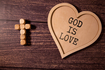 God is love concept text lying on the rustic wooden background.