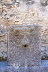Human figure carved in water fountain stone in Pompeii Archaeological Park