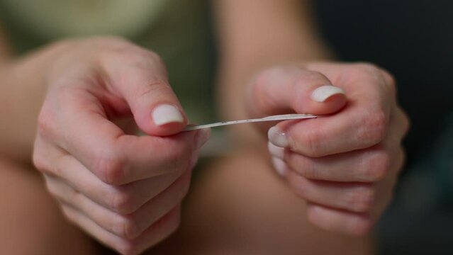 Positive pregnancy test in hand, a woman joyfully anticipates motherhood