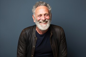 Portrait of a happy senior man with grey hair and beard smiling