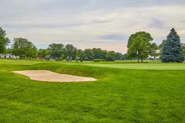 Serene Golf Course with Sand Bunker and Lush Fairway at Dawn