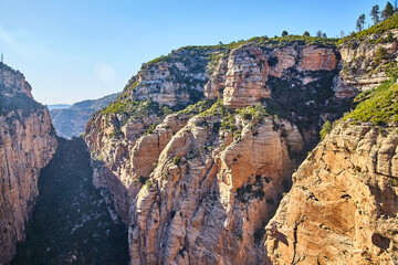 Aerial View of Sunlit Sedona Canyon Cliffs with Sparse Vegetation