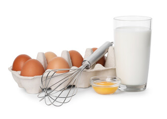 Metal whisk, raw eggs and glass of milk isolated on white