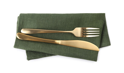 Green napkin with golden fork and knife isolated on white, top view. Cutlery set