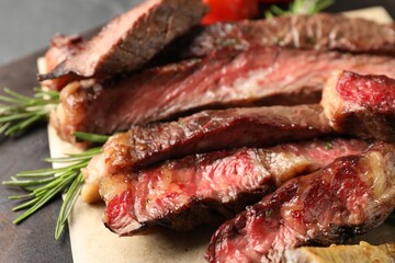 Delicious grilled beef with rosemary on table, closeup