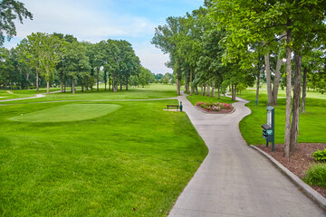 Serene Golf Course Landscape with Winding Path and Sand Bunker