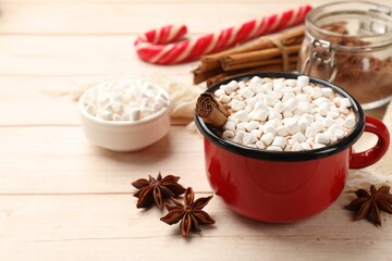 Tasty hot chocolate with marshmallows on white wooden table, closeup. Space for text