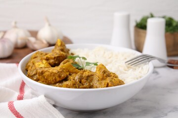 Delicious chicken curry with rice on white marble table, closeup