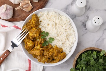 Delicious chicken curry with rice and ingredients on white marble table, flat lay