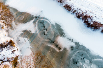 View of a freezing river at the beginning of winter, ice formation on the river from the air