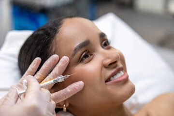 Young dark-skinned woman having a session of mesotherapy