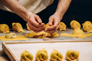 The chef prepares the cappellacci with ricotta and spinach