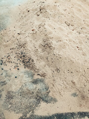 Fine sand for building and laying blocks. Construction material, fine sand spread on the ground