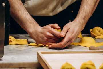 The chef prepares the cappellacci with ricotta and spinach