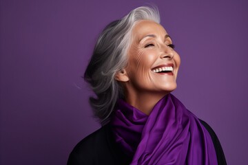 Smiling woman with purple scarf. Beautiful mature woman smiling and looking away while standing...
