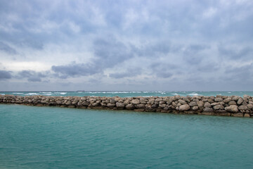 Waves breaking near a rock jetty