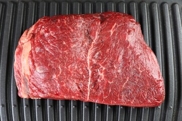 Cooking fresh beef cut on electric grill, top view
