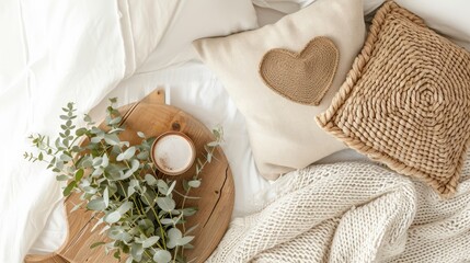 Cozy morning in bed. Cup of coffee, knitted plaid, eucalyptus branches, wicker basket on wooden tray, top view