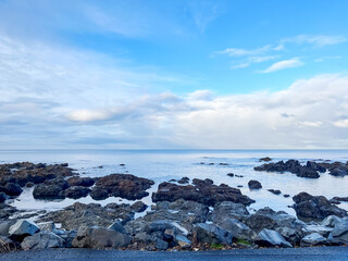 Fototapeta na wymiar Coastal View with Calm Seas and Timeless Rocks Creating a Tranquil Seascape