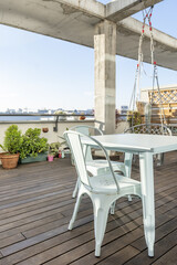An urban terrace with plants and a metal table