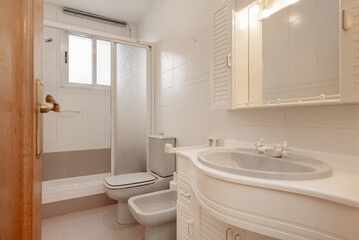 A typical conventional bathroom in a home with a shower cabin