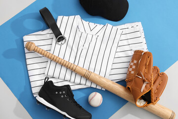 Flat lay composition with baseball uniform and sports equipment on color background
