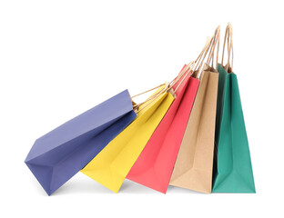 Colorful and kraft paper shopping bags on white background