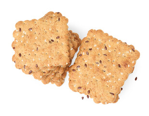 Stacks of cereal crackers with flax and sesame seeds isolated on white, top view