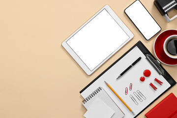 Modern tablet, smartphone, stationery and coffee on beige background, flat lay. Space for text