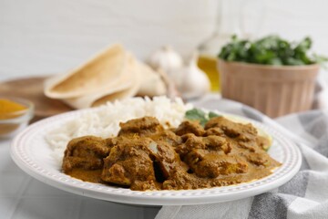 Delicious chicken curry with rice on table, closeup