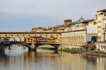 Obraz premium The Ponte Vecchio, a medieval stone closed-spandrel segmental arch bridge over the Arno, in Florence, Italy