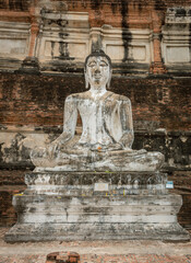 Fototapeta premium Seated bronze stone worship Buddha statue and red brick Thai temples at the Wat Yai Chai Mongkhon in Ayutthaya Thailand