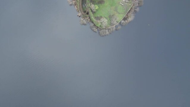  McDermott Castle on an island in Lough Key, County Roscommon, Ireland, surrounded by lush greenery and water, seen from above