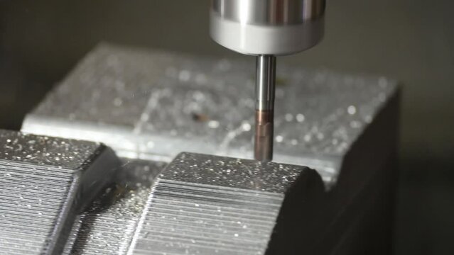 The CNC milling machine cutting press die part by solid bull end mill tool and G-code data background.