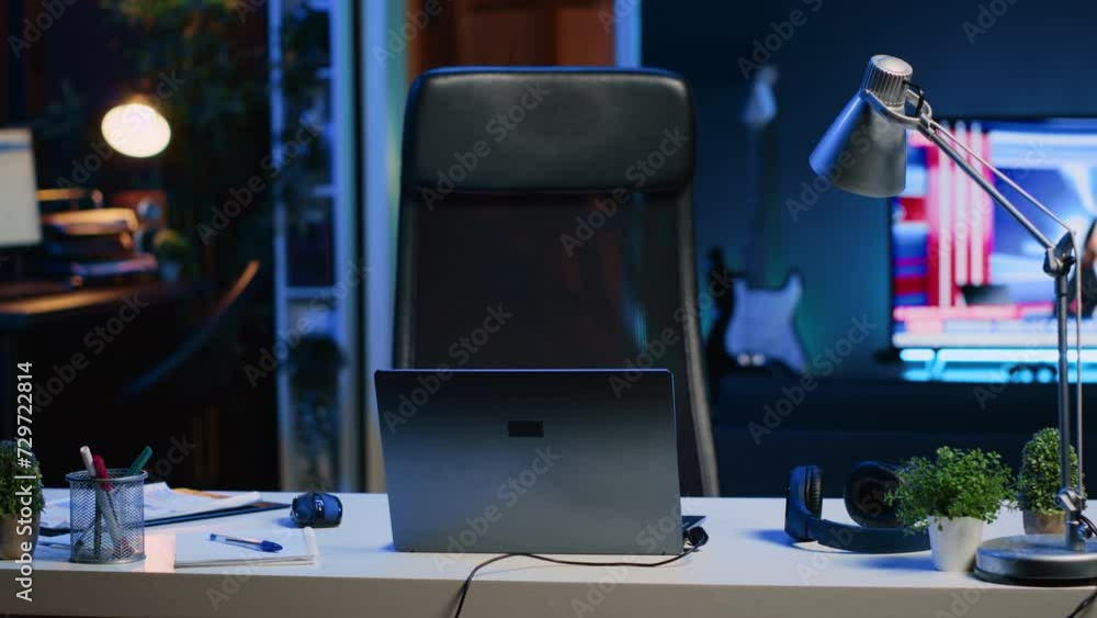 Aufkleber panning shot of personal office desk in front of smart tv displaying news program broadcasting. lapt