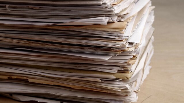 A very large stack of papers. Deadline, office overload, bureaucracy, paperwork