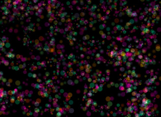 The image shows a group of colorful balls floating slightly out of focus on a black background. Abstract for composition.