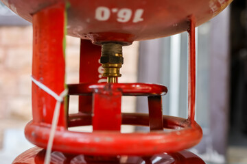 Liquefied Petroleum Gas cylinder refilling through valve close up at day
